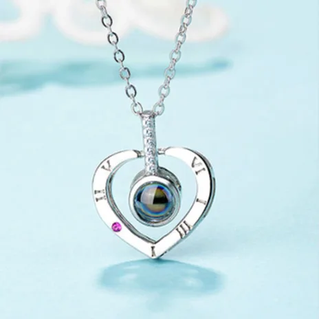 Colgante de corazón en plata "100 maneras de decir te amo"